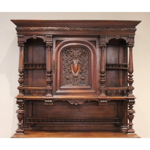 644 - A late 19th/early 20th century French walnut dresser, the raised back with a central carved cupboard... 