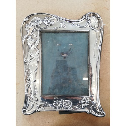 30 - An Art Nouveau silver photograph frame, Samuel M Levi, Birmingham 1907, of shaped rectangular form, ... 