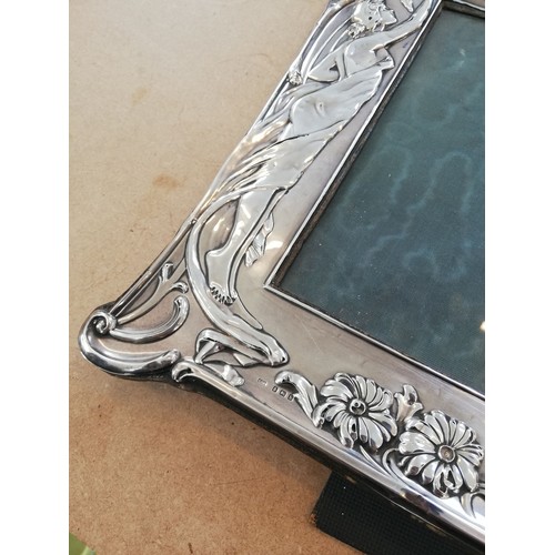 30 - An Art Nouveau silver photograph frame, Samuel M Levi, Birmingham 1907, of shaped rectangular form, ... 