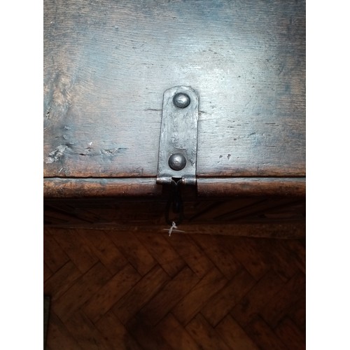 590 - A late 17th/early 18th century oak coffer, the twin plank moulded top opening to a fitted candle box... 