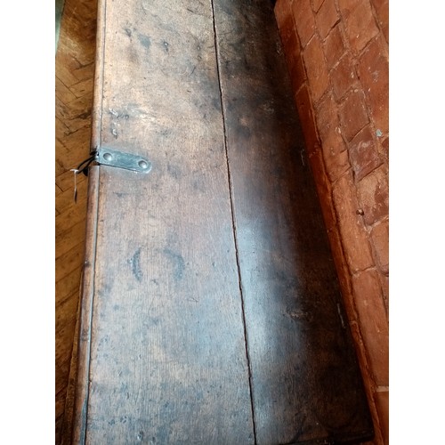 590 - A late 17th/early 18th century oak coffer, the twin plank moulded top opening to a fitted candle box... 