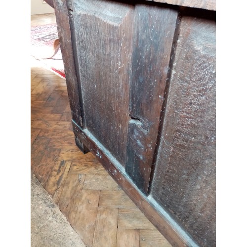 590 - A late 17th/early 18th century oak coffer, the twin plank moulded top opening to a fitted candle box... 