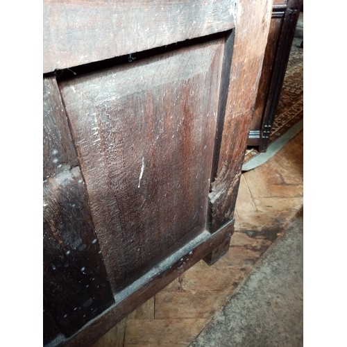 590 - A late 17th/early 18th century oak coffer, the twin plank moulded top opening to a fitted candle box... 