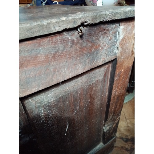 590 - A late 17th/early 18th century oak coffer, the twin plank moulded top opening to a fitted candle box... 