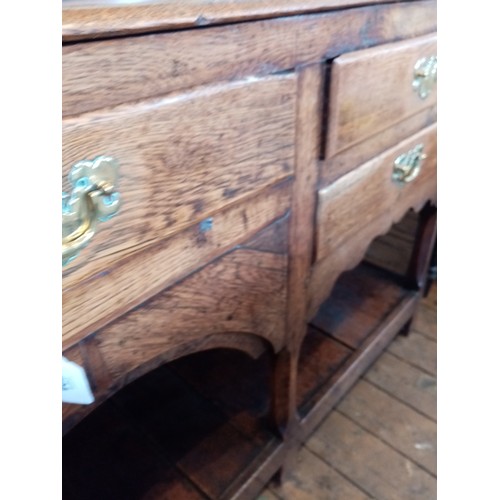 604 - A George III oak high back pot board dresser, the moulded cornice above a scalloped frieze and three... 