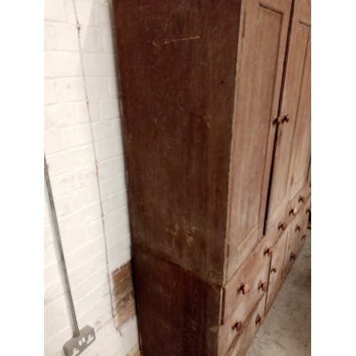 618 - A 19th century scumbled pine housekeepers cupboard, with four panelled cupboard doors above the base... 