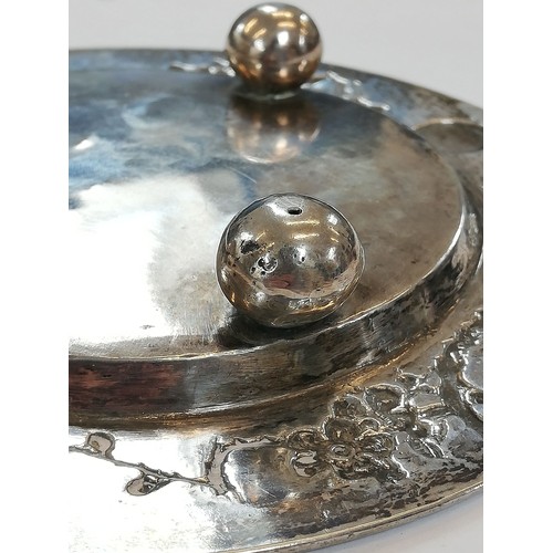 19 - A Chinese silver coloured butter dish, of circular form with detachable cover and circular stand on ... 