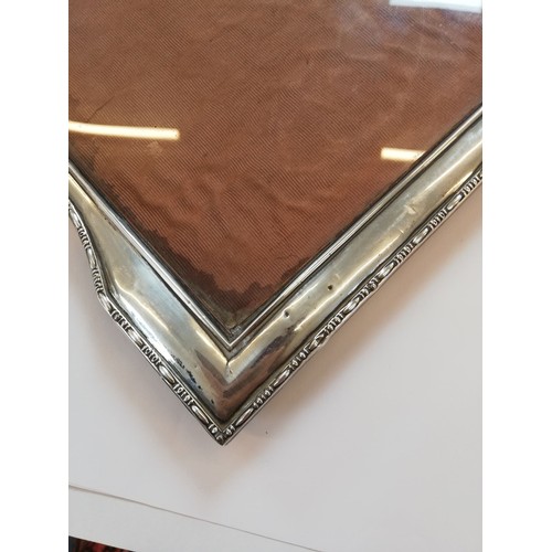 85 - An Art Deco silver mounted photograph frame, Henry Williamson Ltd, Birmingham 1921, of tapered recta... 