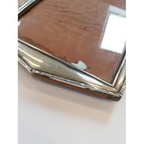 85 - An Art Deco silver mounted photograph frame, Henry Williamson Ltd, Birmingham 1921, of tapered recta... 