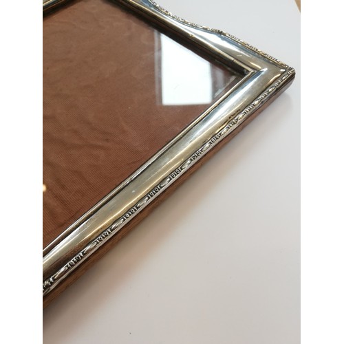 85 - An Art Deco silver mounted photograph frame, Henry Williamson Ltd, Birmingham 1921, of tapered recta... 