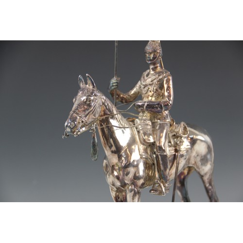 82 - A silver coloured model of a 17th lancer of the Royal Light Brigade, modelled on horseback, all upon... 