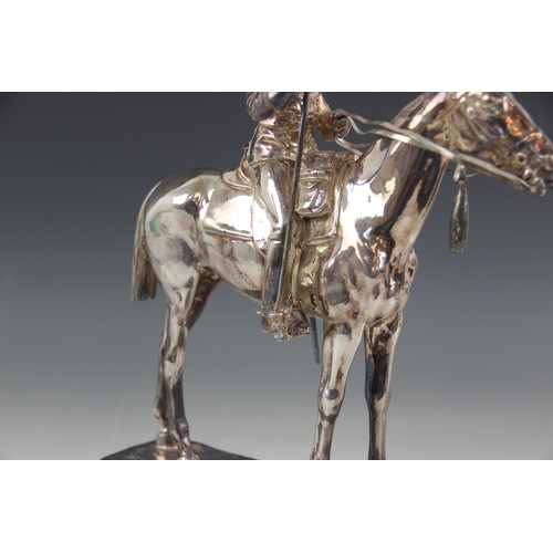 82 - A silver coloured model of a 17th lancer of the Royal Light Brigade, modelled on horseback, all upon... 