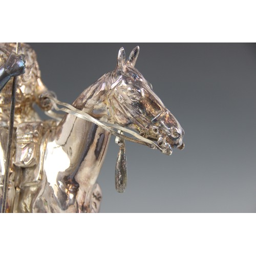 82 - A silver coloured model of a 17th lancer of the Royal Light Brigade, modelled on horseback, all upon... 