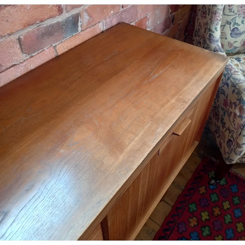 678 - A mid 20th century 'Long John' style teak sideboard, the four central tambour effect drawers flanked... 