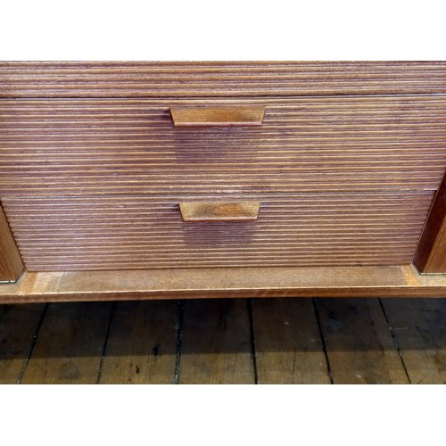 678 - A mid 20th century 'Long John' style teak sideboard, the four central tambour effect drawers flanked... 