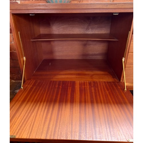 678 - A mid 20th century 'Long John' style teak sideboard, the four central tambour effect drawers flanked... 