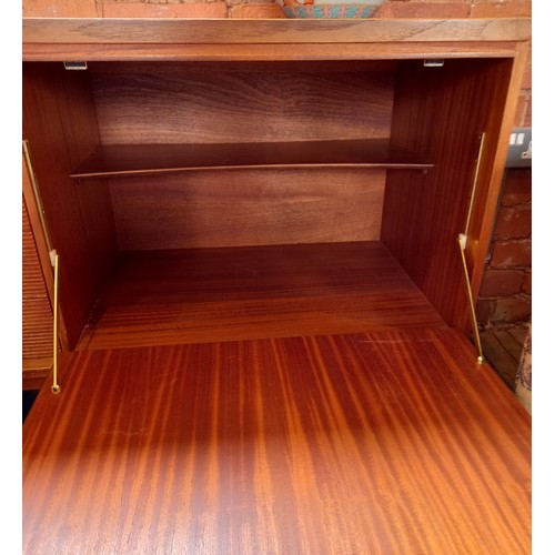 678 - A mid 20th century 'Long John' style teak sideboard, the four central tambour effect drawers flanked... 