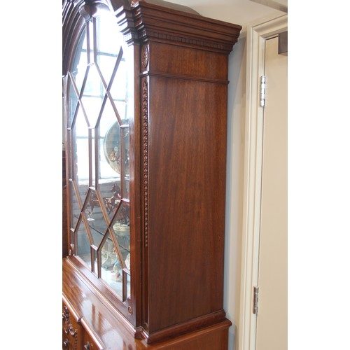 664A - A Queen Anne style mahogany display cabinet, late 20th century, the arched top flanked by fruit fini... 