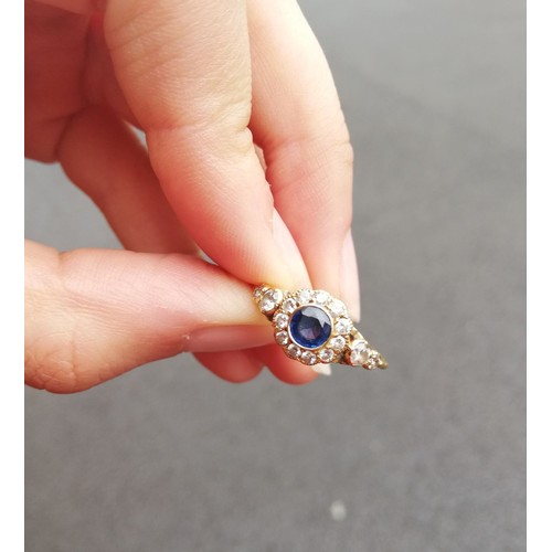 117 - An early 20th century sapphire and diamond floral cluster ring, the central round mixed cut sapphire... 