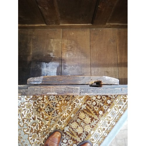 587 - An early 18th century oak coffer, the three plank top opening to a fitted candle box, above the thre... 