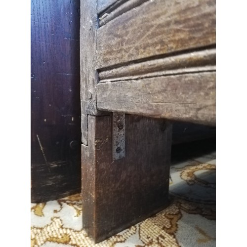 587 - An early 18th century oak coffer, the three plank top opening to a fitted candle box, above the thre... 