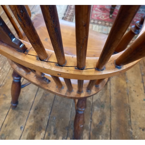 589 - A 19th century yew and ash hoop back Windsor elbow chair, with a pierced splat over a shaped seat ra... 