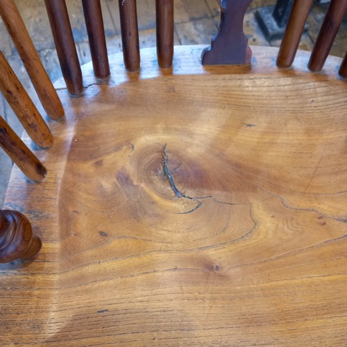 589 - A 19th century yew and ash hoop back Windsor elbow chair, with a pierced splat over a shaped seat ra... 