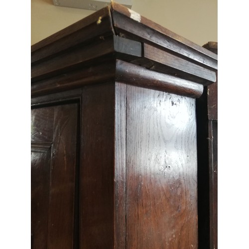 614 - A George III oak freestanding corner cupboard, the single full length door with two fielded panels o... 