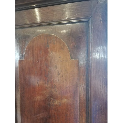 614 - A George III oak freestanding corner cupboard, the single full length door with two fielded panels o... 