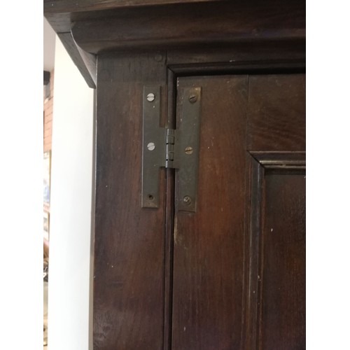 614 - A George III oak freestanding corner cupboard, the single full length door with two fielded panels o... 