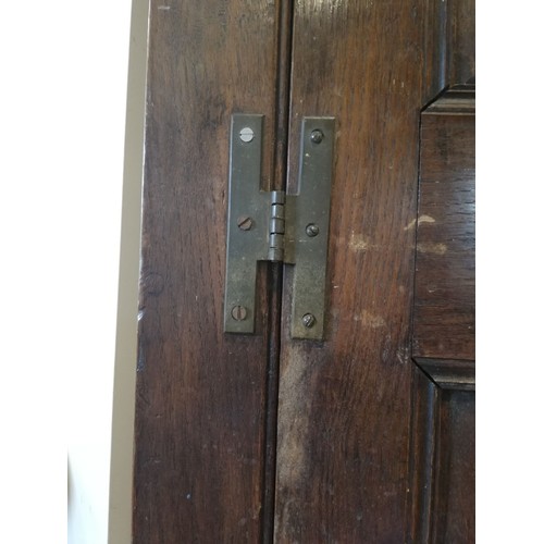 614 - A George III oak freestanding corner cupboard, the single full length door with two fielded panels o... 