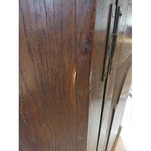 614 - A George III oak freestanding corner cupboard, the single full length door with two fielded panels o... 