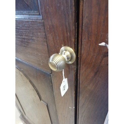 614 - A George III oak freestanding corner cupboard, the single full length door with two fielded panels o... 