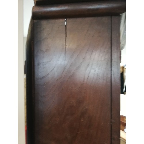 614 - A George III oak freestanding corner cupboard, the single full length door with two fielded panels o... 