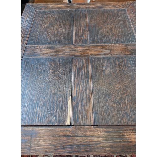 670 - An Arts & Crafts oak draw leaf table, purchased from Liberty, the rectangular draw leaf top above a ... 