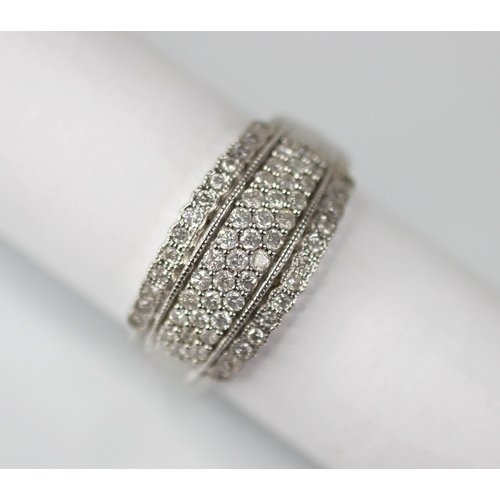 103 - A diamond set 18ct white gold ring, the raised central channel pave set with three rows of round mix... 