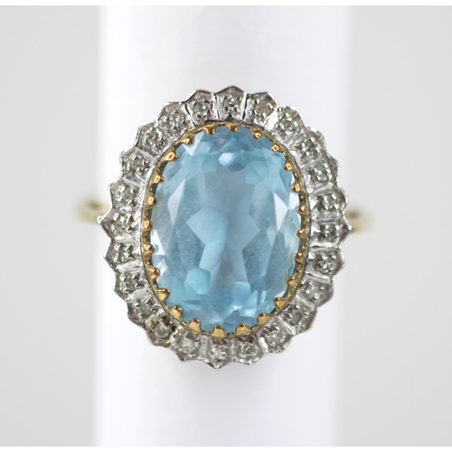 119 - A blue topaz and diamond 9ct gold cluster ring, the oval mixed cut topaz measuring 14mm x 9mm, set t... 