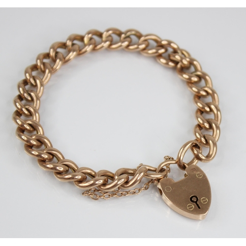 123 - A Victorian gold coloured curb link bracelet, jump-links stamped '9CT', approximately 18cm long, sus... 