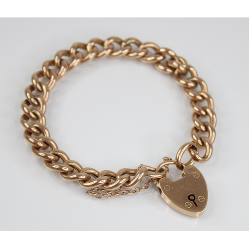 123 - A Victorian gold coloured curb link bracelet, jump-links stamped '9CT', approximately 18cm long, sus... 