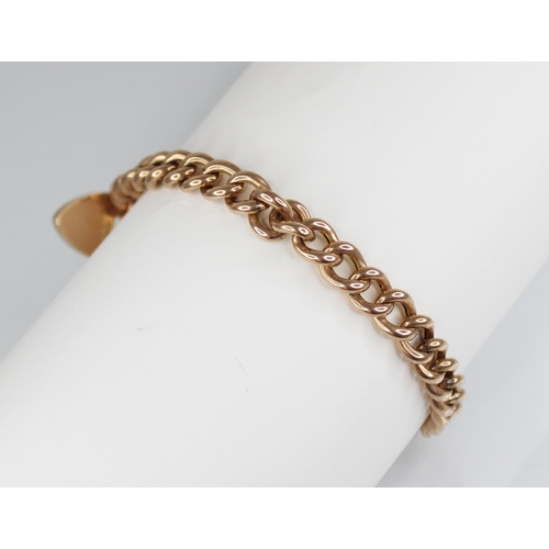 123 - A Victorian gold coloured curb link bracelet, jump-links stamped '9CT', approximately 18cm long, sus... 