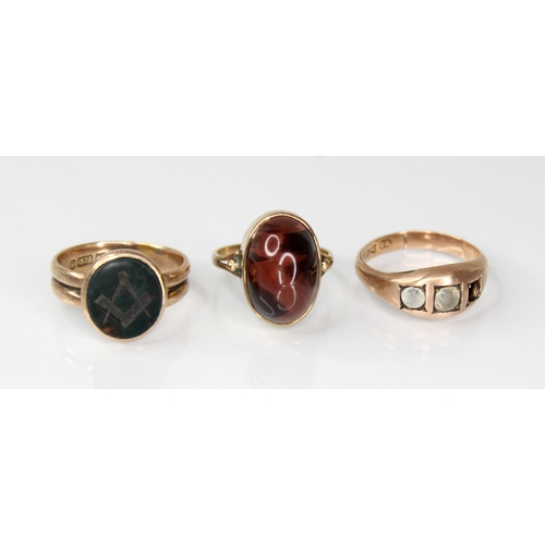 131 - A Victorian 9ct gold bloodstone set Masonic ring, the oval bloodstone head engraved with compass and... 