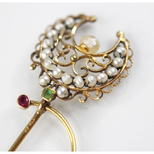 136 - A 19th century French pearl, peridot and ruby set 18ct gold stick pin, modelled as a crescent moon w... 