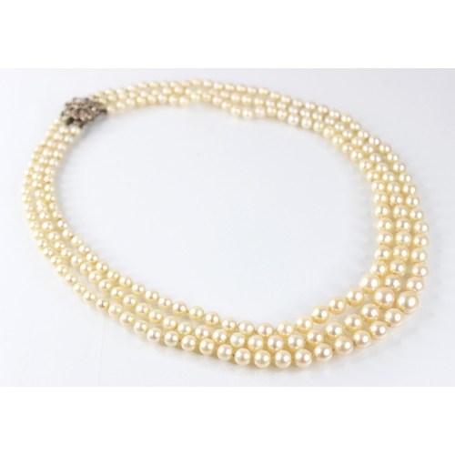 138 - A cultured pearl necklace, comprising three rows of graduated round cultured pearls measuring betwee... 