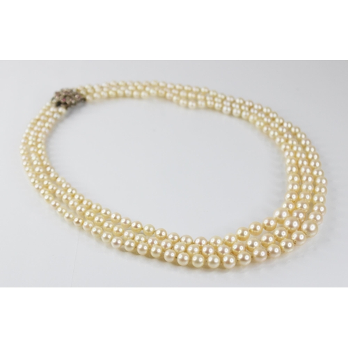 138 - A cultured pearl necklace, comprising three rows of graduated round cultured pearls measuring betwee... 