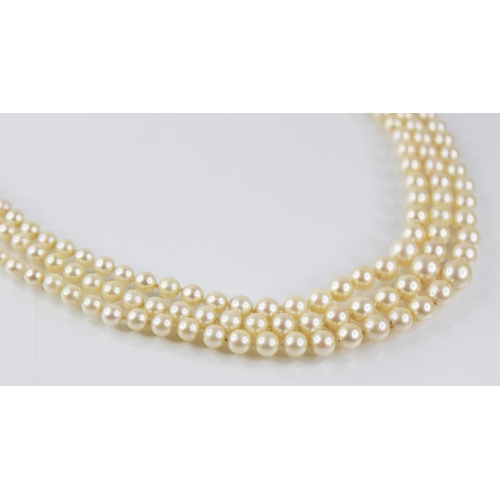 138 - A cultured pearl necklace, comprising three rows of graduated round cultured pearls measuring betwee... 