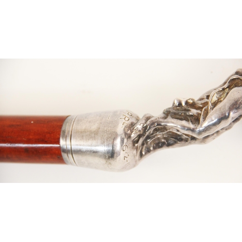 155 - A stained beech wood cane, early 20th century, mounted with a cast metal Rolls Royce 