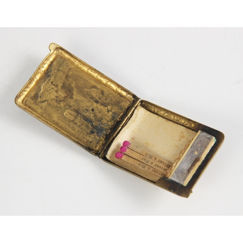 156 - A brass and enamel compact, early 20th century, of rectangular form with engine turned detail and fo... 