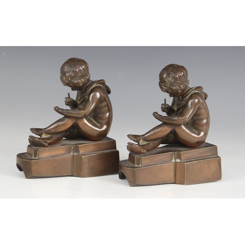 157 - A pair of French bronze bookends, early 20th century, each modelled as a scribing cherub, each 11.5c... 