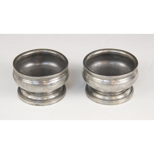 158 - A pair of early 19th century pewter salts, each of compressed circular form on pedestal foot, touch ... 