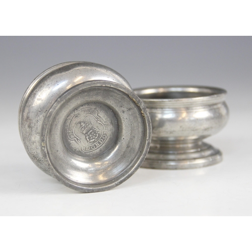 158 - A pair of early 19th century pewter salts, each of compressed circular form on pedestal foot, touch ... 